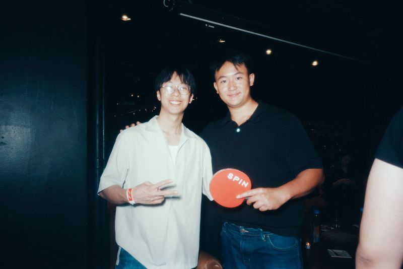 Two guests posing with a paddle