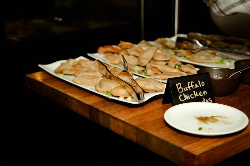 Buffalo chicken bites on a wooden serving board