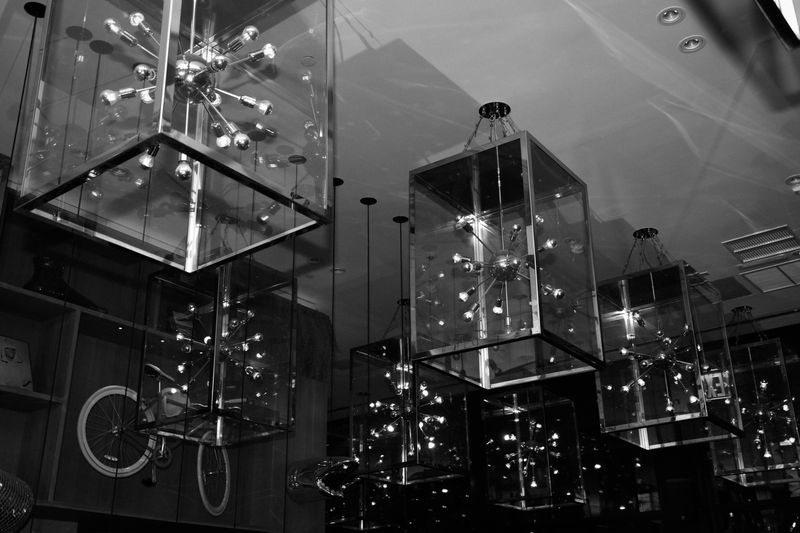 Glass cube chandeliers overhead, in black and white